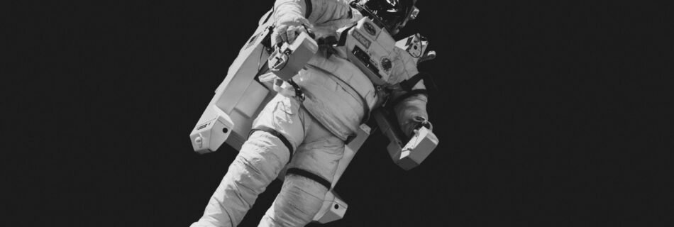 astronaut in white suit in grayscale photography